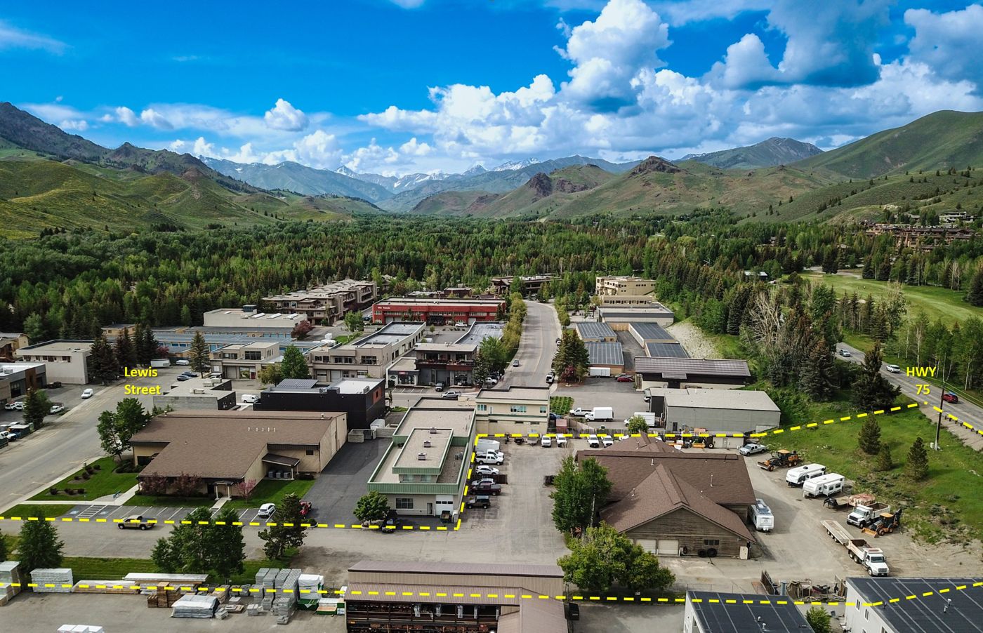 Aerial view of the Project Lookout site at 330 Lewis Street, Ketchum, Idaho, with the site boundary marked along Lewis Street and Highway 75 and the Sawtooth mountains in the background